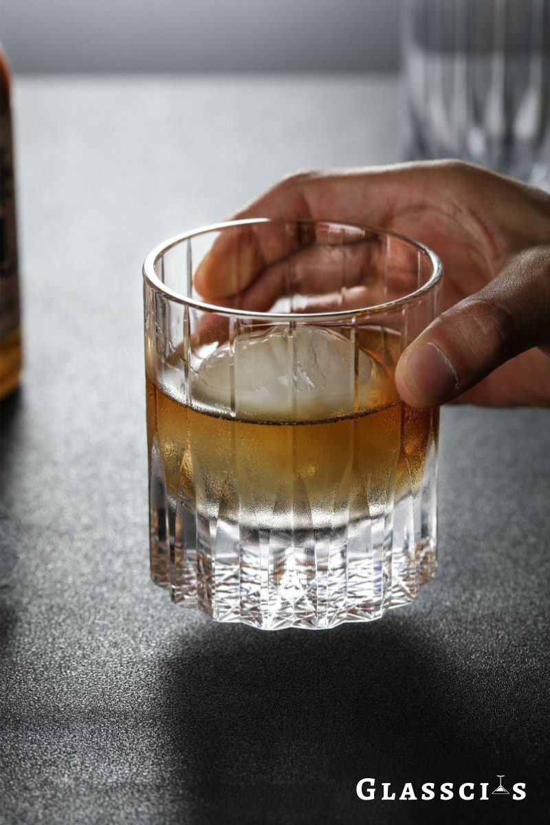 someone holding edo glass from a table
