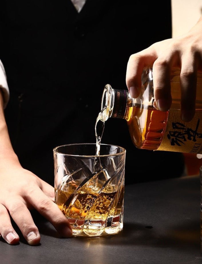 Elegant spinning whiskey glass with claw mark designs by Glasscias