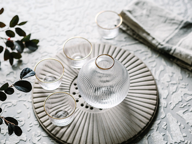 Sleek glass sake set with gold accents