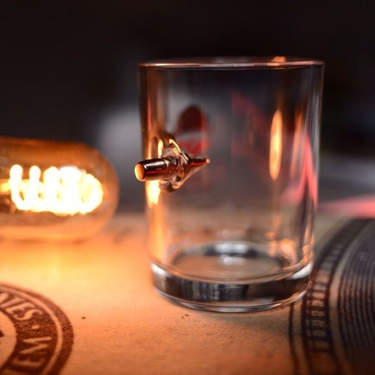 Bullet seemingly suspended mid-flight in transparent glass