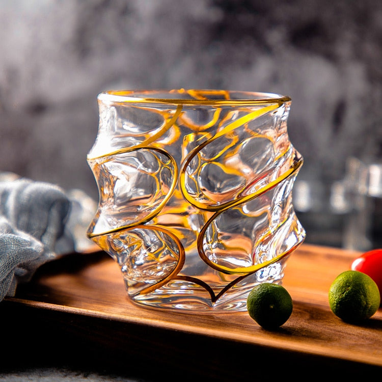 Spiraled gold rim glassware adorned with gold edging, reflecting luxury