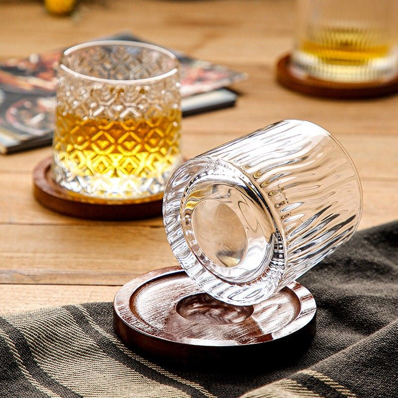 a round bottom whiskey glass with vertical lines design