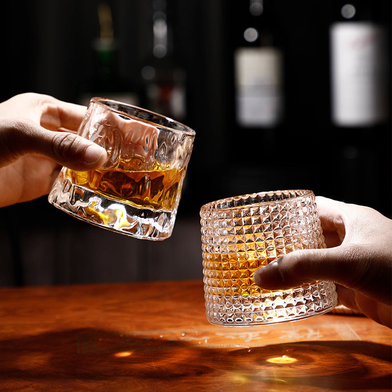 cheering with two spinning whiskey glasses