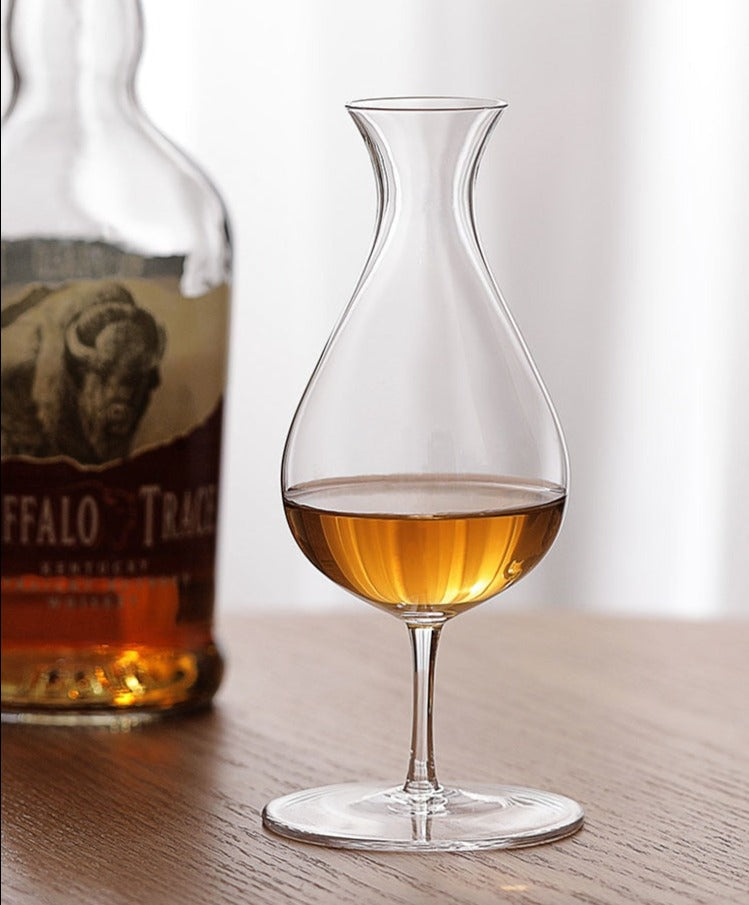 fancy tulip whiskey glass on a bar