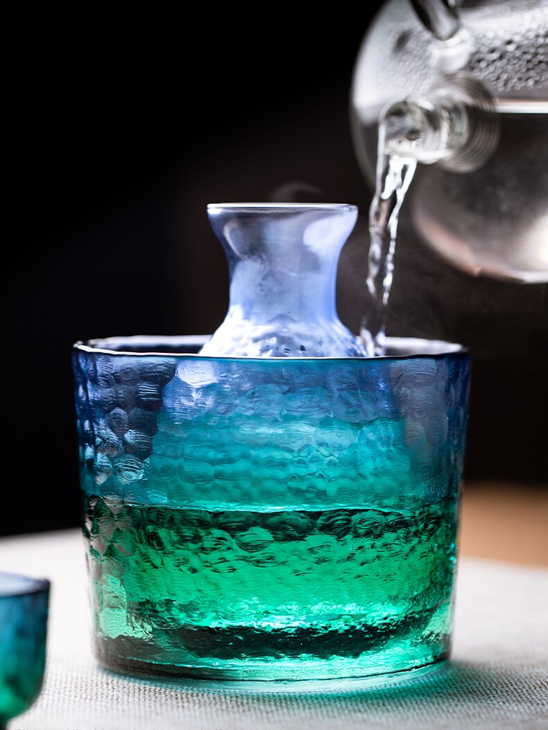hot water poured on a sake set with warmer