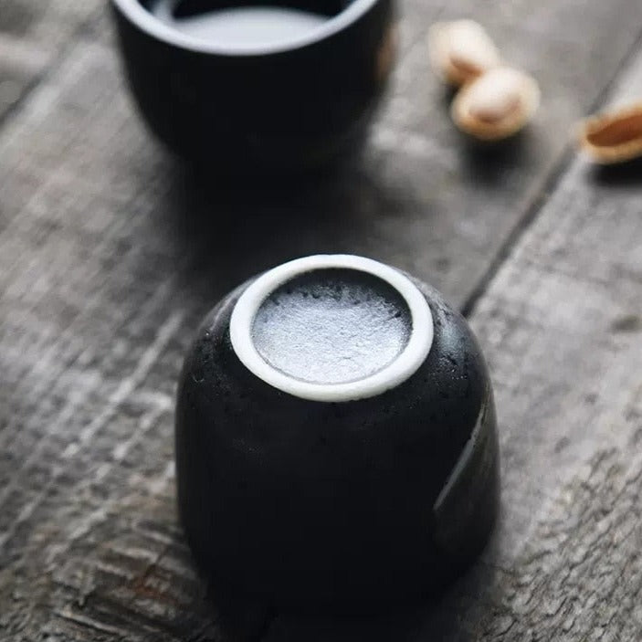 upside down black sake cup with gold brushline design