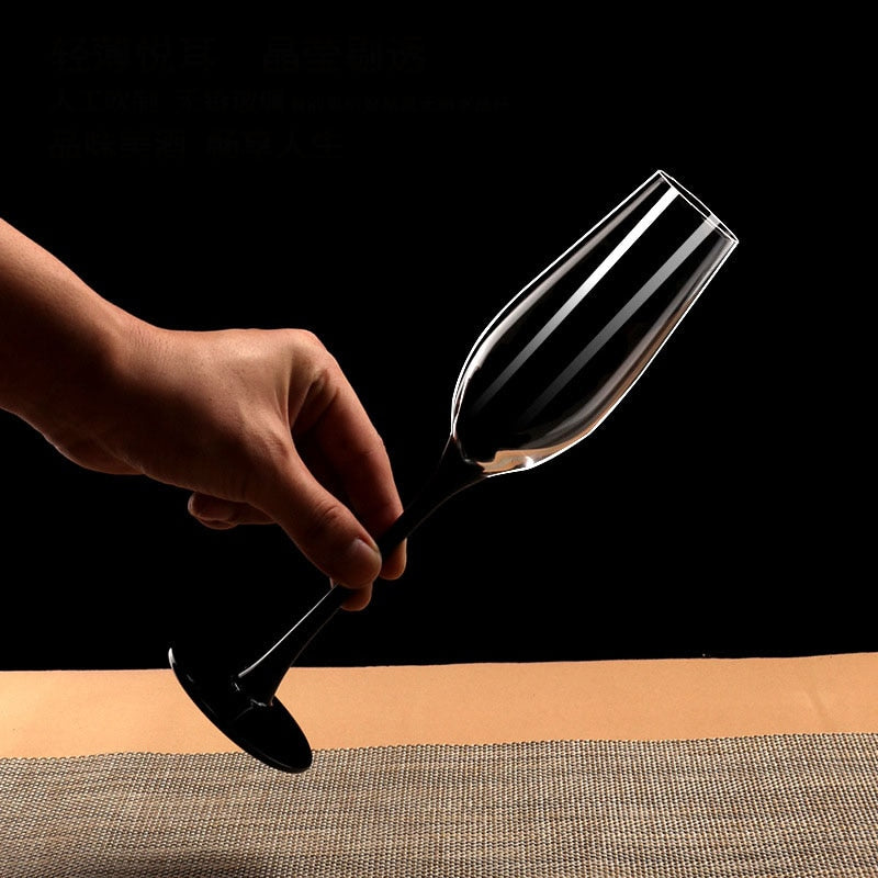 Champagne bubbles in a stylish black stemmed glass