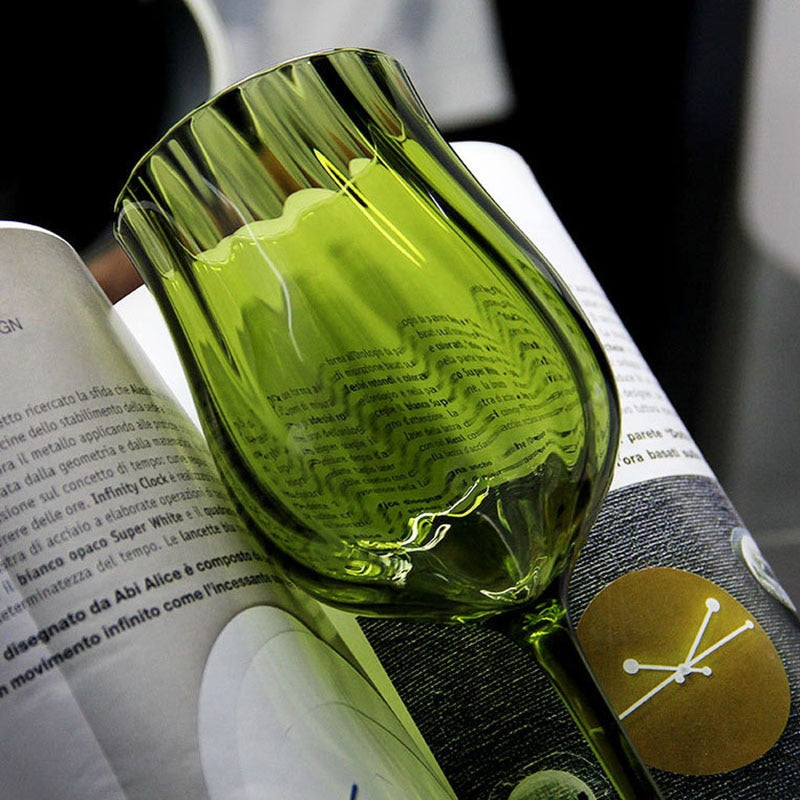 Close-up of green wine glass reflecting light