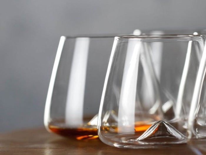 Sophisticated whiskey glass, merging minimalism with a distinctive mountain base design