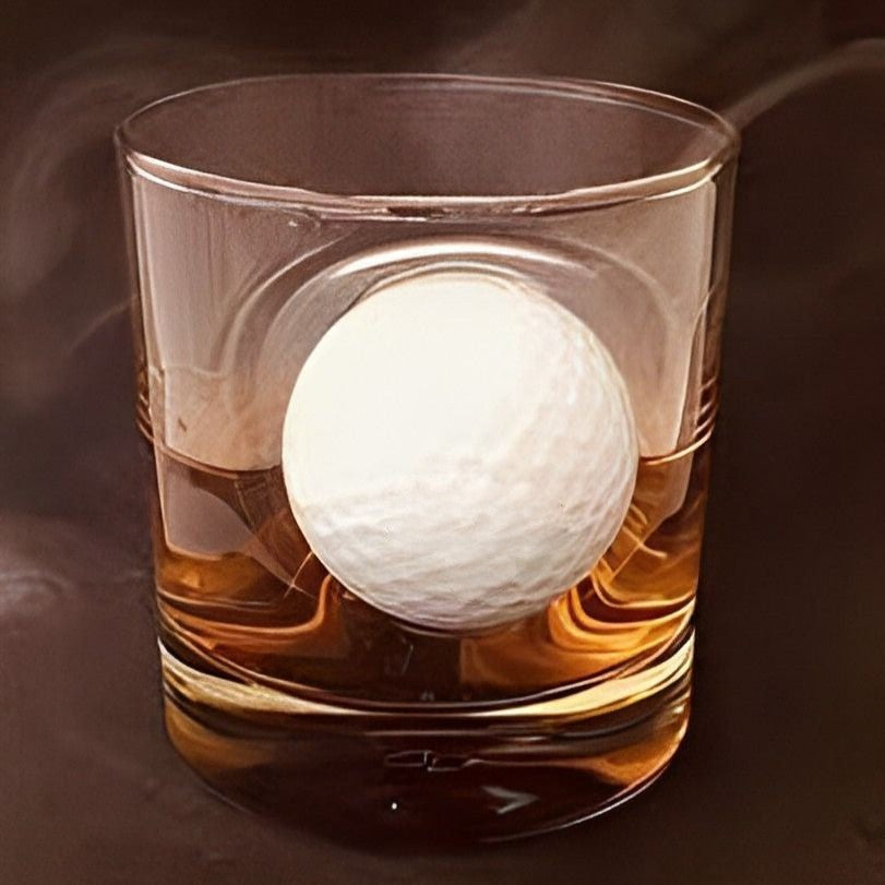 Whimsical golf ball trapped in whiskey glass design
