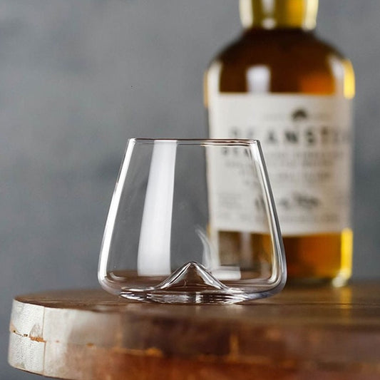 Hand-crafted whiskey glass featuring a unique mountain design at the bottom
