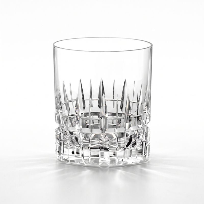 Cathedral cut crystal whiskey glass with tall pointed cuts above a band of block cuts, front view