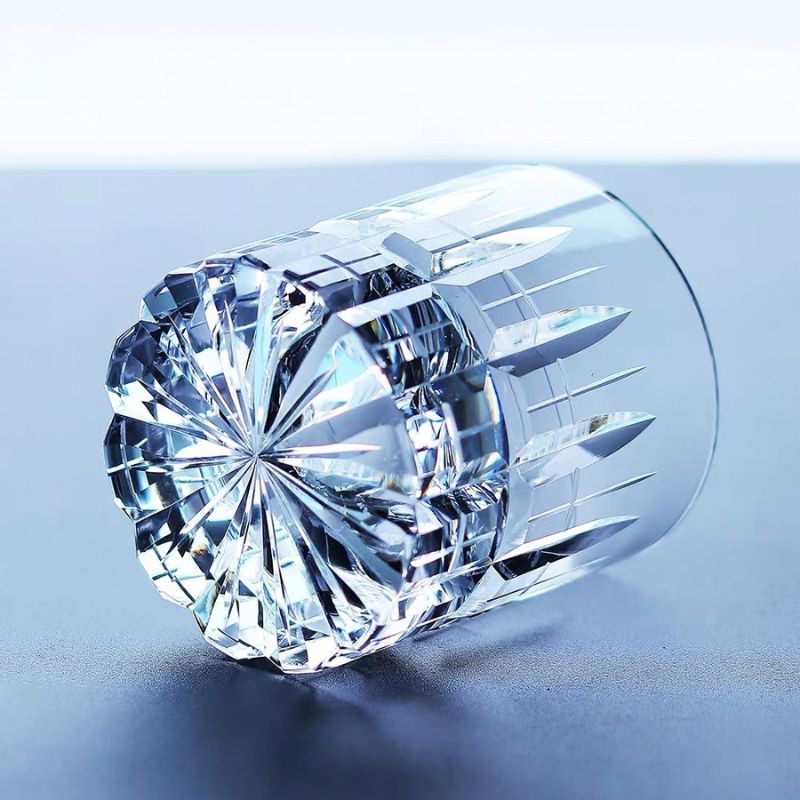 Cut crystal whiskey glass lying on its side, showing the radiating base cut and spire cuts