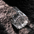 Hand-cut crystal whiskey glass lying on stone in sunlight