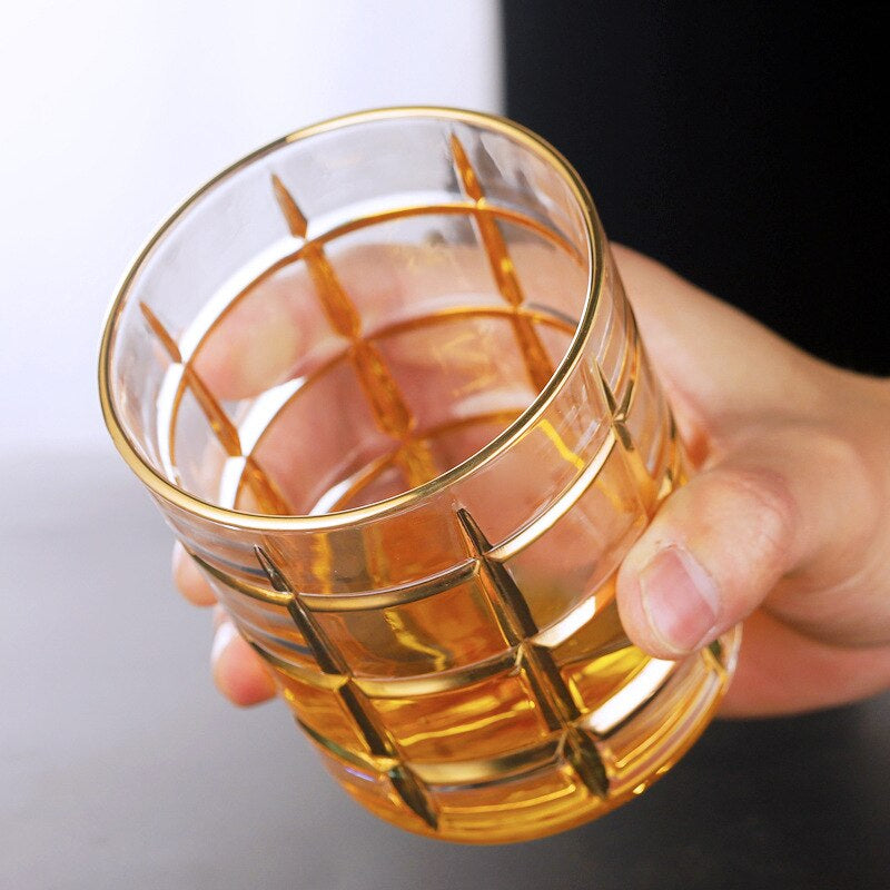 Elegant gold rimmed drinking glass resembling a castle's grand gate