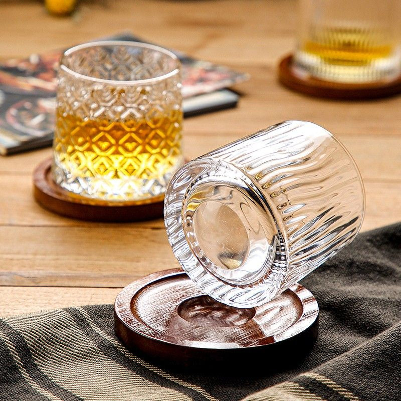 a round bottom whiskey glass with vertical  lines design