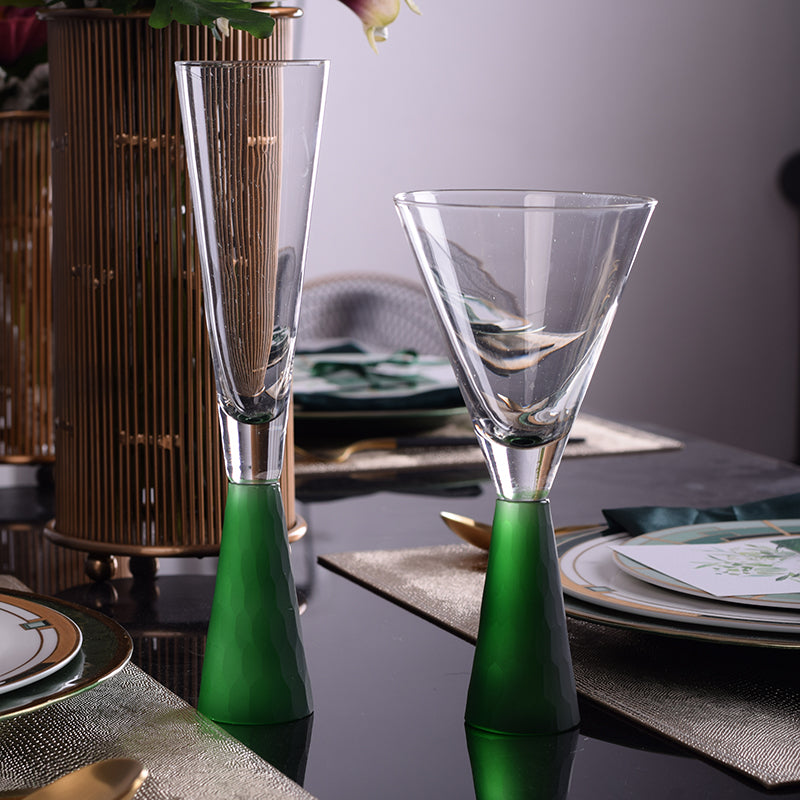 Hourglass-shaped champagne wine glasses with emerald stems