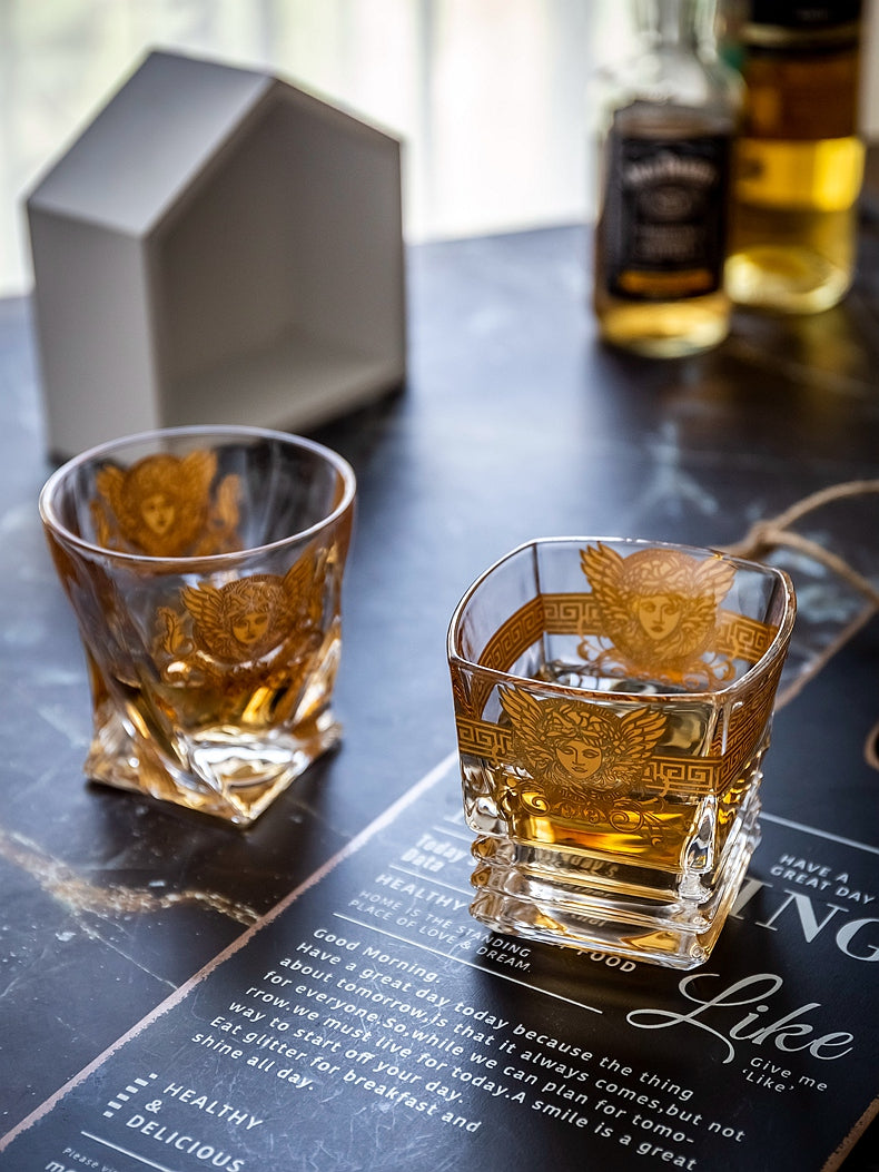 Celebratory Medusa design on a gold whiskey glass