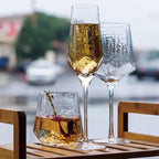 A set of geometric wine glasses display on a wooden rack | Glasscias