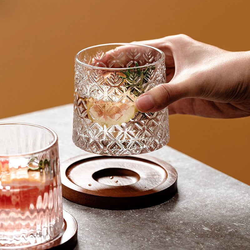 Whiskey glass rocking on a table, showcasing its snowflake etchings