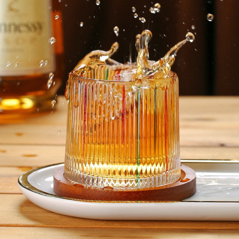 Colorful hand-painted vertical stripes on whiskey glass