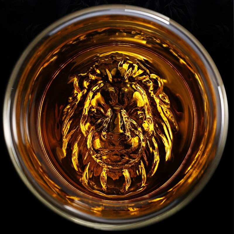 Transparent whiskey glass with lion base design