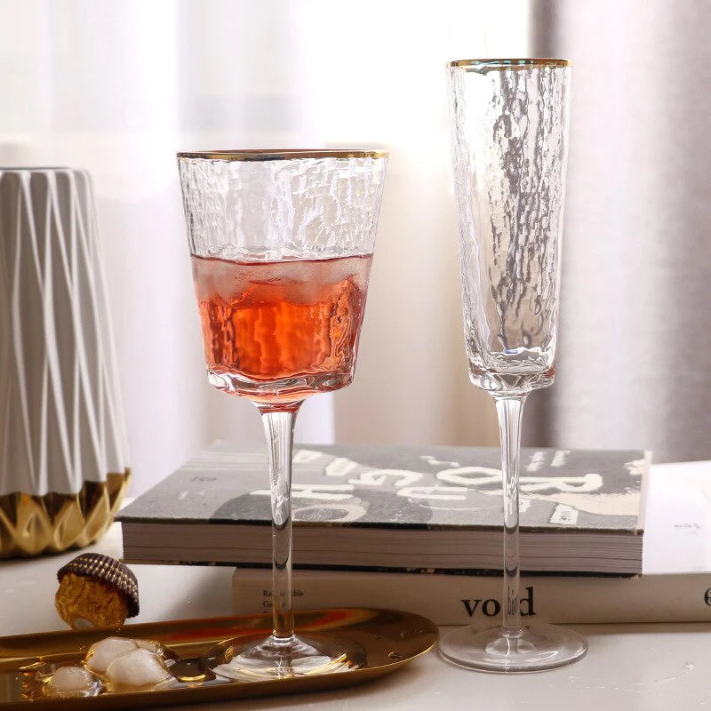 Celebratory hand blown wine glasses with an opulent gold rim by Glasscias
