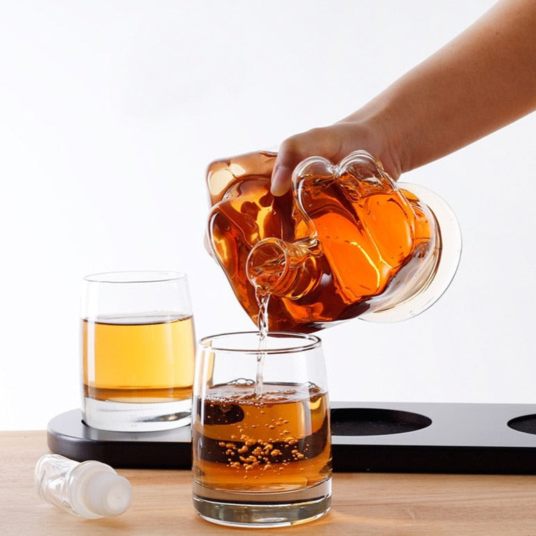 a man pouring whiskey from a funny decanter