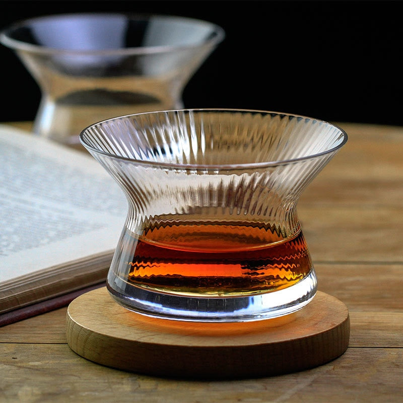 A neat whisky glass on a wooden coaster | Glasscias