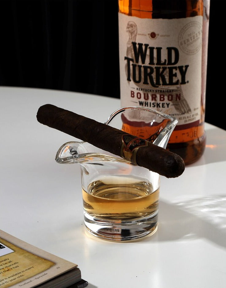 Curvy whiskey glass seamlessly holding a cigar