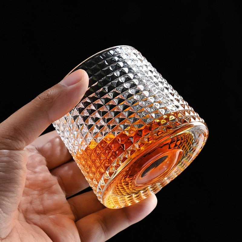 someone holding a unique diamond grid whiskey glass