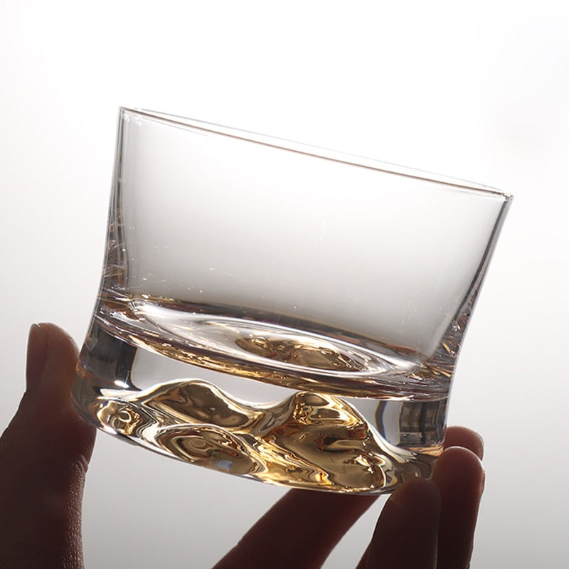 Whiskey glass with gold mountain design at the base