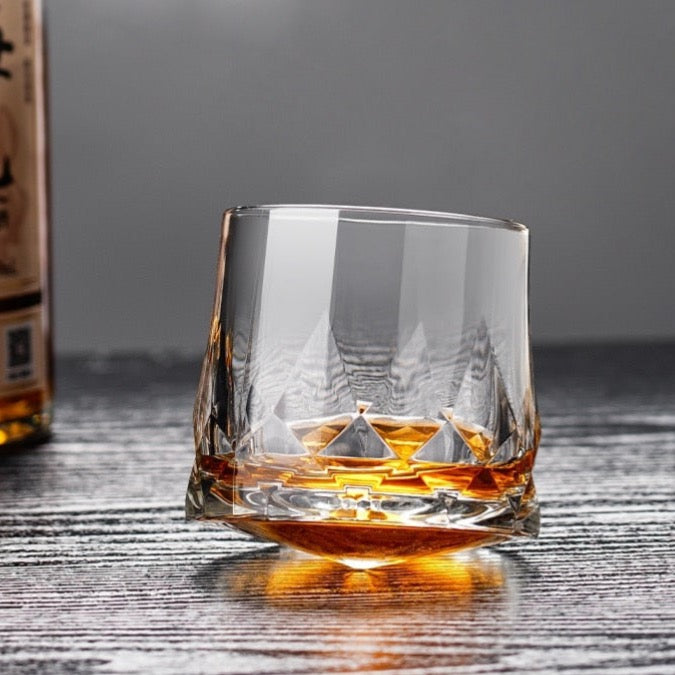 Elegant whiskey glass with intricate diamond cuts and unique rocker design