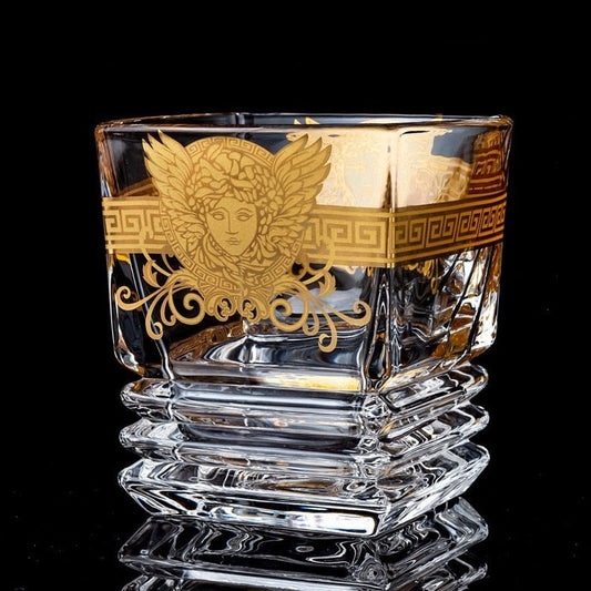 Gold whiskey glass with Medusa design