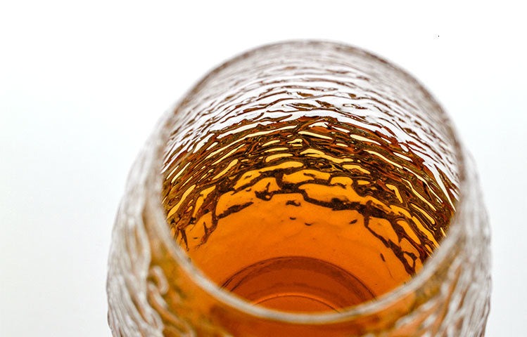 Traditionally crafted whiskey glass with distinctive hammered texture
