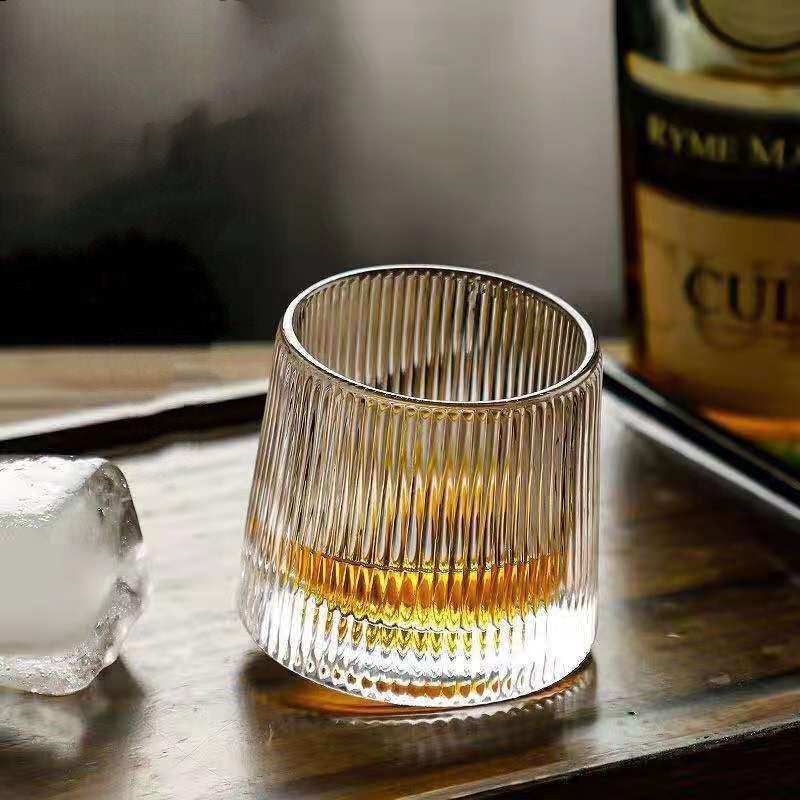 Elegant Rocking Whiskey Glass with Vertical Ribbed Texture by Glasscias